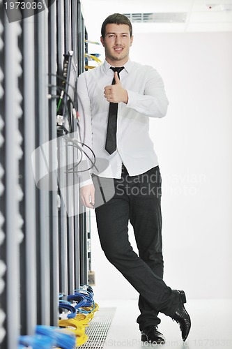 Image of young engeneer in datacenter server room