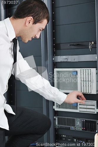 Image of young engeneer in datacenter server room