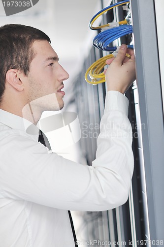 Image of young engeneer in datacenter server room