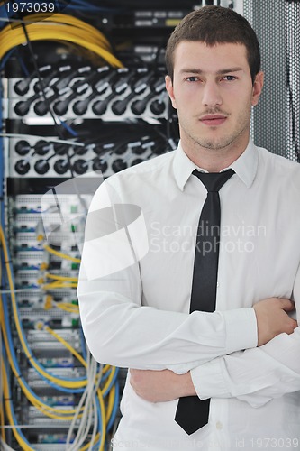 Image of young engeneer in datacenter server room