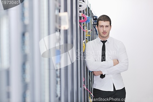 Image of young engeneer in datacenter server room