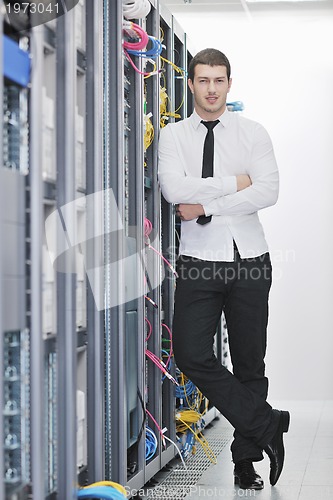 Image of young engeneer in datacenter server room