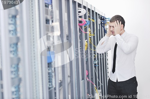 Image of young engeneer in datacenter server room