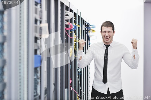 Image of young engeneer in datacenter server room