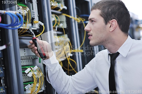 Image of young engeneer in datacenter server room