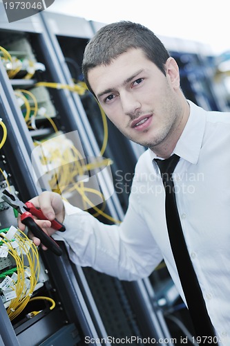 Image of young engeneer in datacenter server room