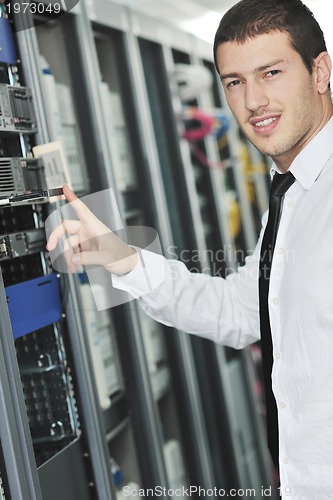 Image of young engeneer in datacenter server room