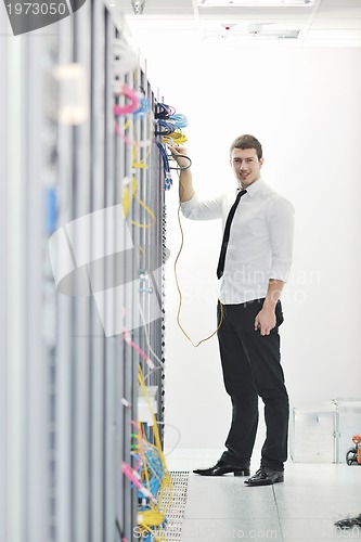 Image of young engeneer in datacenter server room