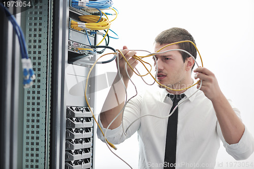 Image of young engeneer in datacenter server room