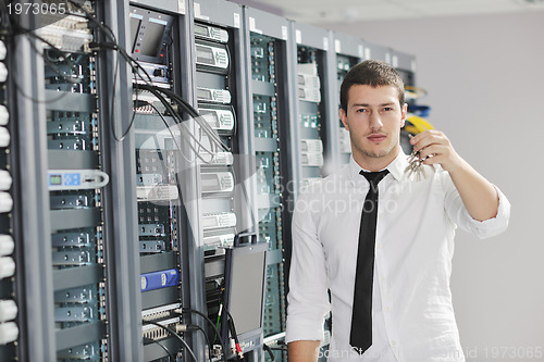 Image of young engeneer in datacenter server room