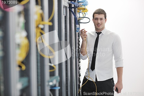 Image of young engeneer in datacenter server room