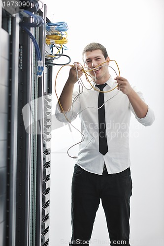 Image of young engeneer in datacenter server room