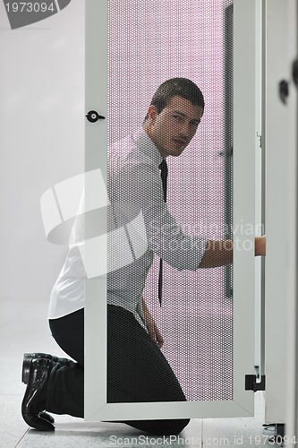 Image of young engeneer in datacenter server room