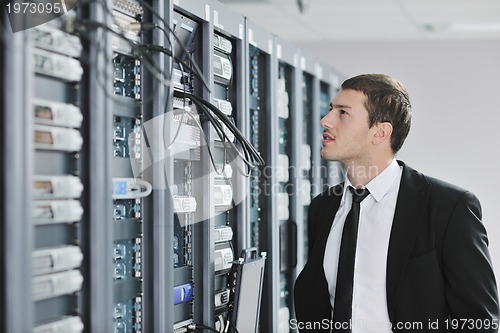 Image of young engeneer in datacenter server room