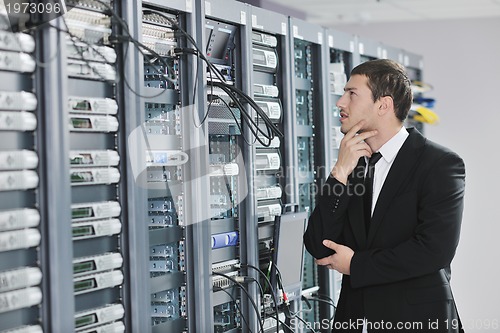 Image of young engeneer in datacenter server room