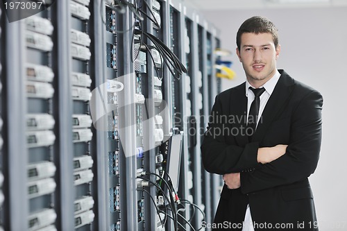 Image of young engeneer in datacenter server room