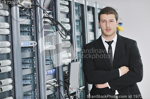 Image of young engeneer in datacenter server room