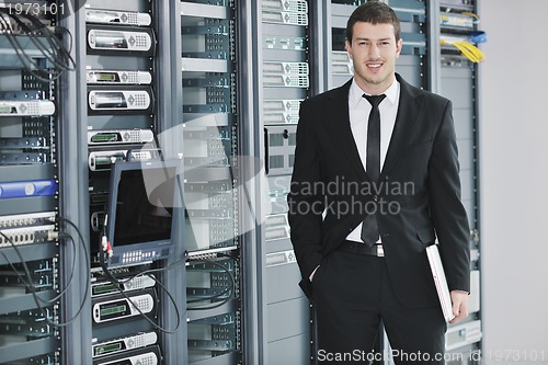 Image of young engeneer in datacenter server room