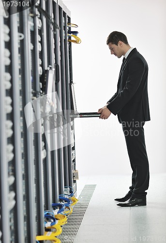 Image of young engeneer in datacenter server room