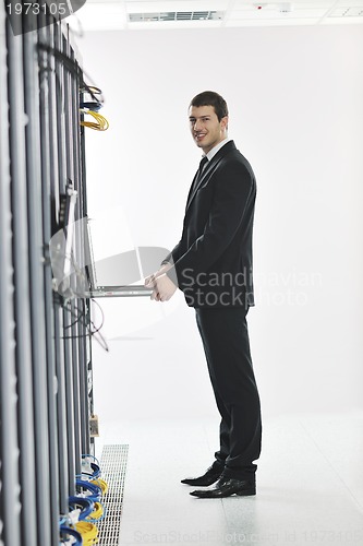 Image of young engeneer in datacenter server room