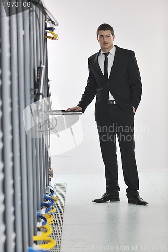 Image of young engeneer in datacenter server room