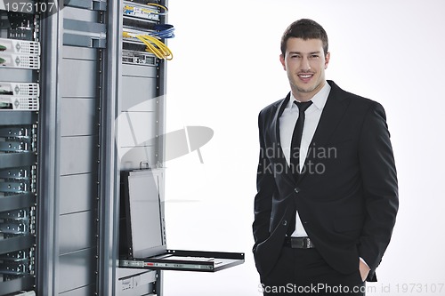 Image of young engeneer in datacenter server room