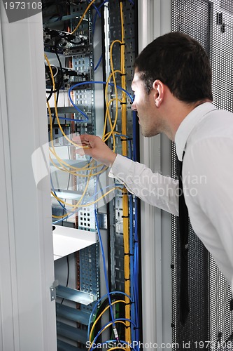 Image of young engeneer in datacenter server room