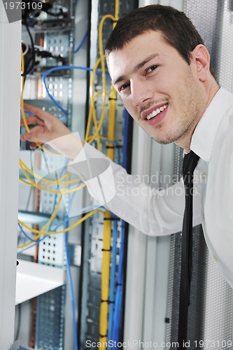 Image of young engeneer in datacenter server room