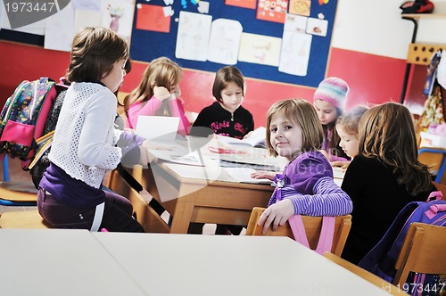 Image of happy kids with  teacher in  school classroom