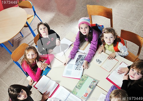 Image of happy kids with  teacher in  school classroom