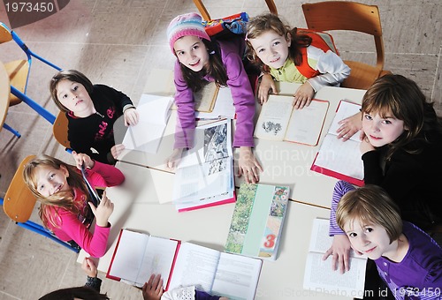 Image of happy kids with  teacher in  school classroom