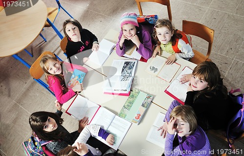 Image of happy kids with  teacher in  school classroom