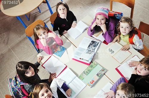 Image of happy kids with  teacher in  school classroom