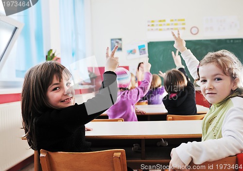 Image of happy kids with  teacher in  school classroom