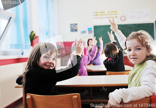 Image of happy kids with  teacher in  school classroom