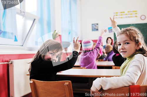 Image of happy kids with  teacher in  school classroom