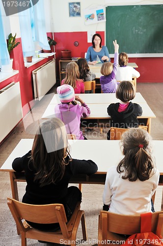 Image of happy kids with  teacher in  school classroom