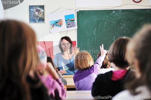 Image of happy kids with  teacher in  school classroom