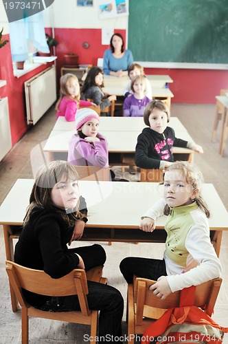 Image of happy kids with  teacher in  school classroom