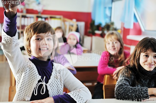 Image of happy kids with  teacher in  school classroom