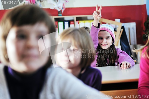 Image of happy kids with  teacher in  school classroom