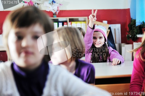 Image of happy kids with  teacher in  school classroom