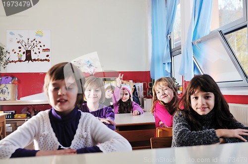 Image of happy kids with  teacher in  school classroom