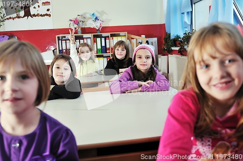 Image of happy kids with  teacher in  school classroom