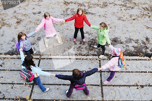 Image of school girls running away