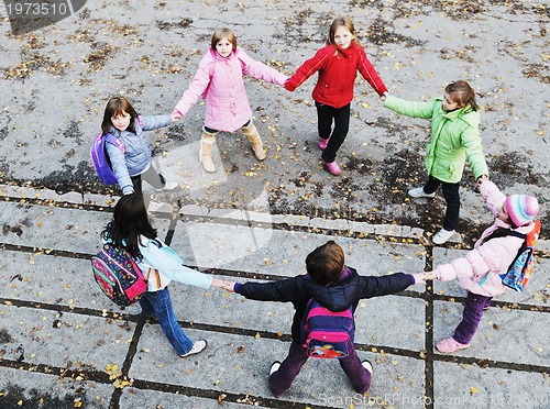 Image of school girls running away