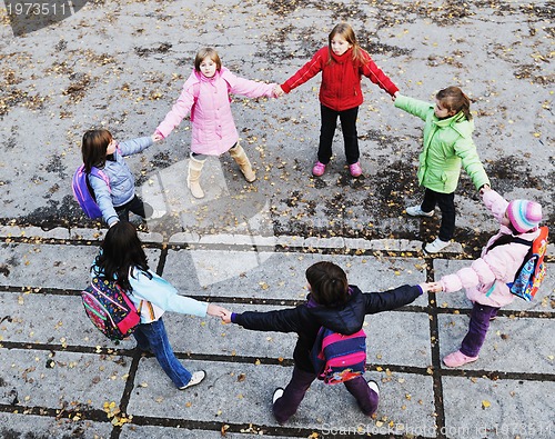 Image of school girls running away