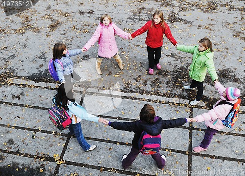Image of school girls running away