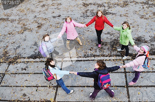 Image of school girls running away