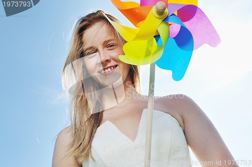 Image of beautiful bride outdoor with colorful windmill toy